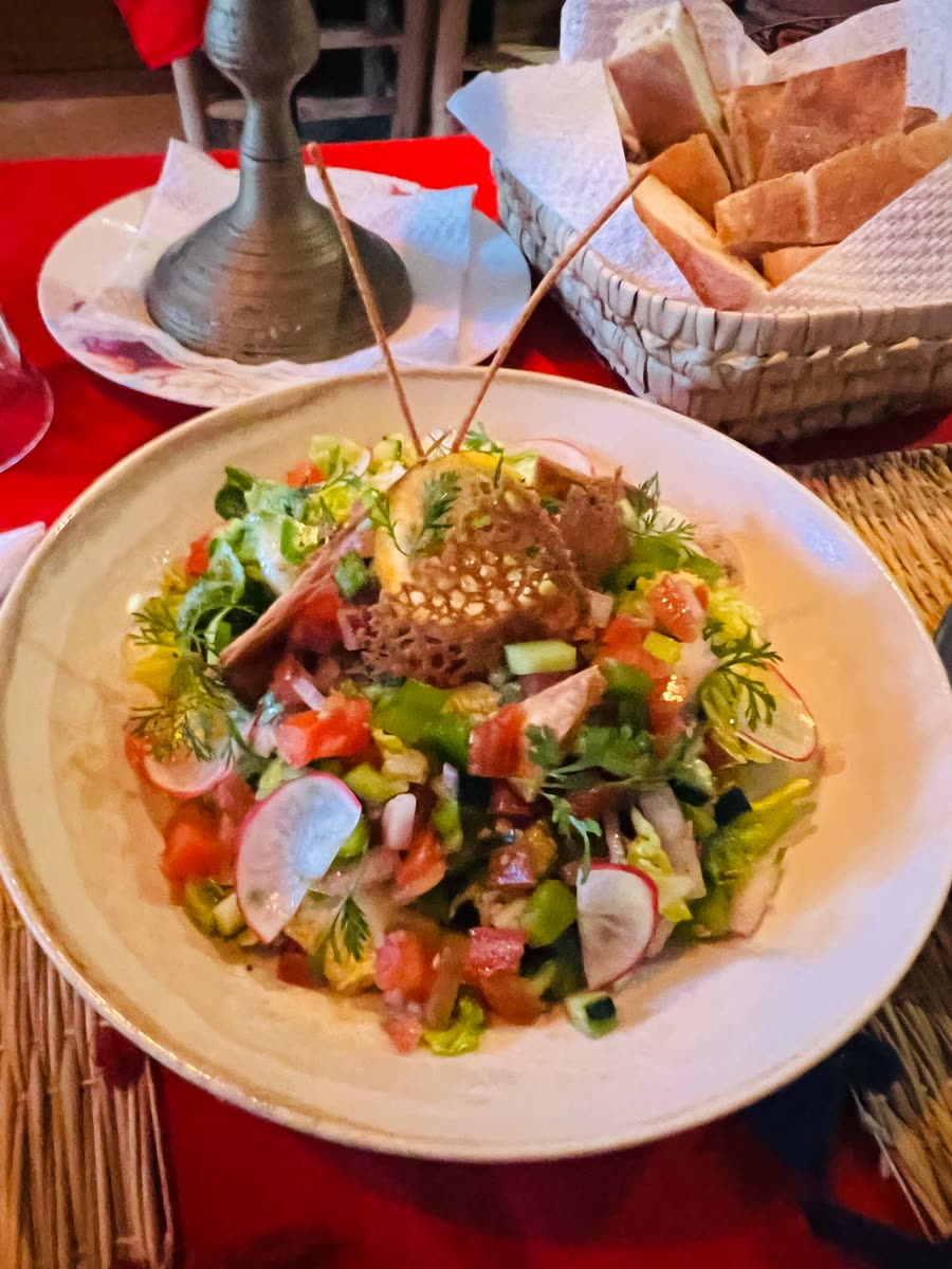 Fresh Moroccan salad with tomatoes, cucumber, radish, herbs and a crispy sesame basket